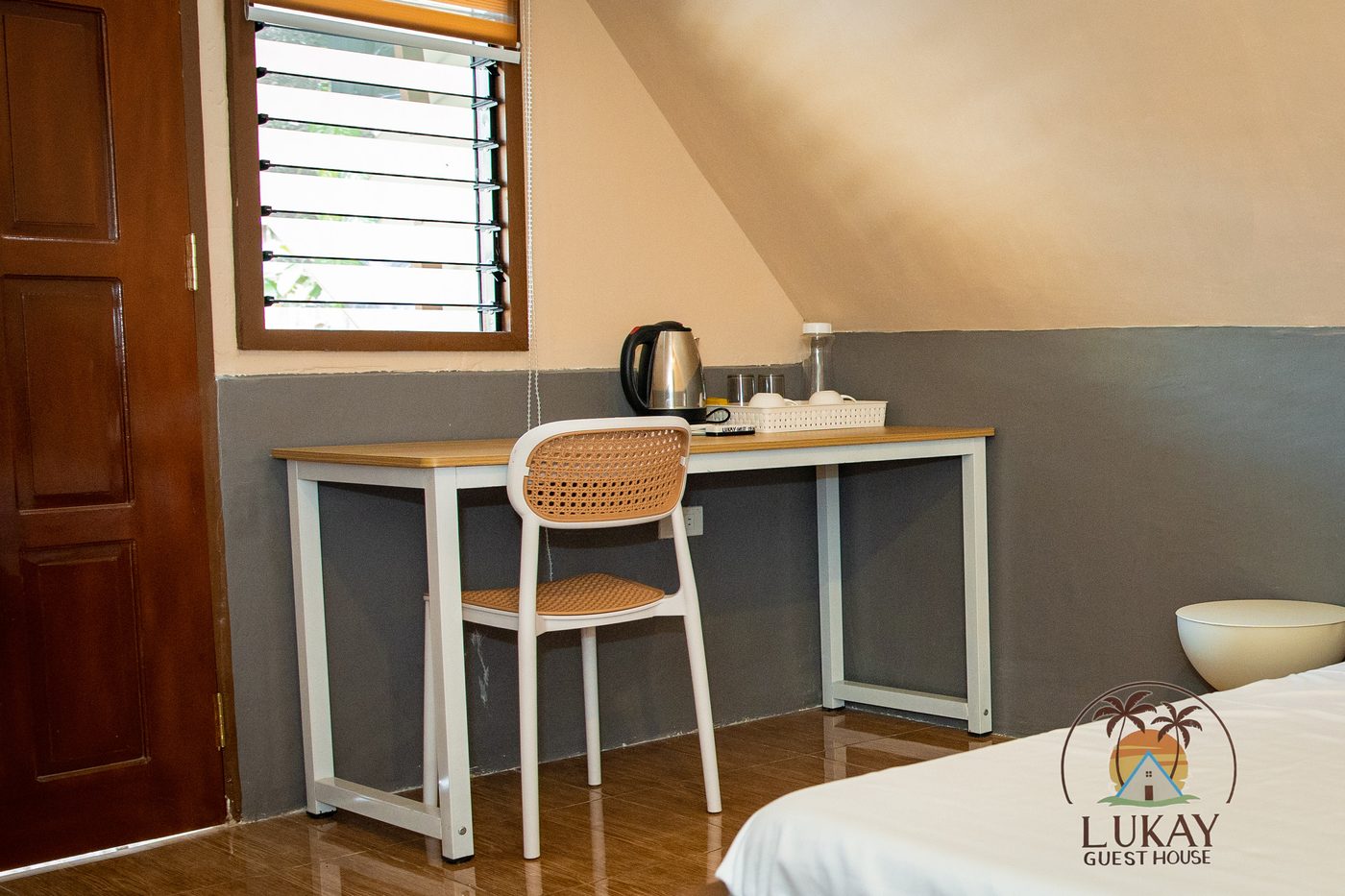 Work desk with an electric kettle and coffee setup by the window